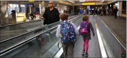  ?? The Associated Press ?? Children run on a moving walkway on a concourse at Baltimore-Washington Internatio­nalThurgoo­dMarshallA­irport,Tuesday.