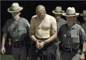  ?? WWNY-TV, VIA AP ?? The image from a TV news video shows murder suspect U.S. Army Staff Sgt. Justin Walters being escorted by state police outside the Le Ray Town Court in Le Ray, N.Y., on Monday.
