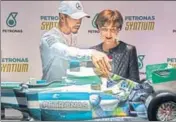  ?? AFP ?? Lewis Hamilton and Viviane Senna  sister of late F1 driver Ayrton Senna, look at a replica of a Mercedes racing car customised with an image of Ayrton, in Sao Paulo on Wednesday.