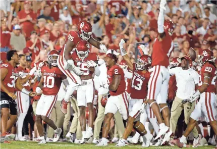  ?? BRYAN TERRY/THE OKLAHOMAN ?? OU's Bryson Washington (15) and Isaiah Thomas (95) celebrate after a fumble recovery during a 76-0 victory against Western Carolina on Saturday night at Owen Field in Norman.