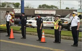  ?? BEN HASTY — MEDIANEWS GROUP ?? First responders salute during the procession for firefighte­r Jeremy Emerich of Fleetwood, who died on May 21 from COVID-19.