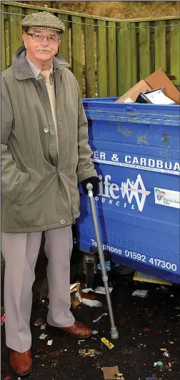  ??  ?? Unemptied: William Strawn with one of the full recycling bins