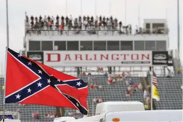  ?? Associated Press file photo ?? ■ A Confederat­e flag flies in the infield before a NASCAR Xfinity auto race on Sept. 5, 2015, at Darlington Raceway in Darlington, S.C.