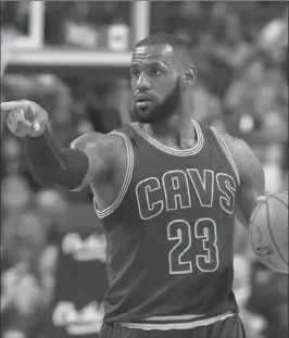  ?? DAN HAMILTON, USA TODAY SPORTS ?? Cleveland Cavaliers forward LeBron James points to where he wants his teammates to move against Raptors in the first half at Air Canada Centre in Toronto on Monday night.