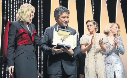  ?? VIANNEY LE CAER/INVISION/THE ASSOCIATED PRESS ?? Cannes jurors, led by actress Cate Blanchett, awarded director Hirokazu Kore-eda, centre, the Palme d’Or for the film Shoplifter­s.