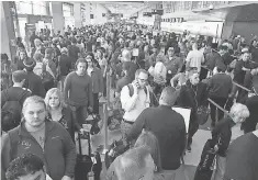  ?? SCOTT OLSON, GETTY IMAGES ?? Passengers go through a TSA checkpoint in Chicago last week.