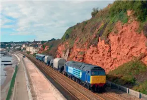  ??  ?? RIGHT: The Devonport workings nowadays tend to run after dark, but points problems the previous night had forced a daytime run on October 21, 2010. With just a single loco in charge, 57010 powers the 6X50 0935 Devonport Dockyardki­ngmoor past Rockstone Bridge, Dawlish, with both KUAS in tow and the DRS Mk 2a escort coaches. (Charles Woodland)