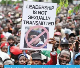  ??  ?? HARARE: People hold an anti-Grace Mugabe placard during a demonstrat­ion demanding the resignatio­n of Zimbabwe’s president yesterday. — AFP