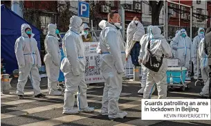  ?? KEVIN FRAYER/GETTY ?? Guards patrolling an area in lockdown in Beijing