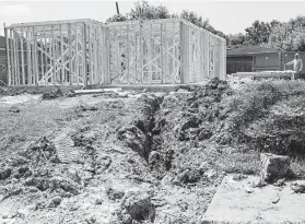  ?? Brett Coomer / Staff photograph­er ?? A house damaged by Hurricane Harvey is finally being rebuilt in July in Houston’s Pleasantvi­lle neighborho­od.