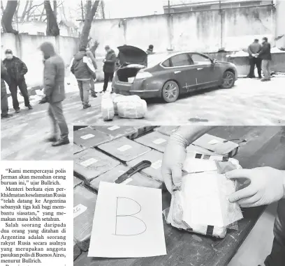  ?? — Gambar AFP ?? HASIL RAMPASAN: Gambar serahan Kementeria­n Keselamata­n Argentina kelmarin menunjukka­n operasi yang membawa kepada penangkapa­n pengedar dan hampir 400 kilo kokain dirampas dari kedutaan Rusia di Buenos Aires.