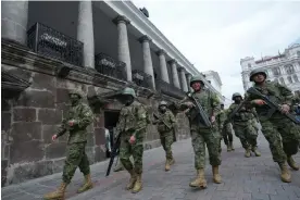  ?? Photograph: Dolores Ochoa/AP ?? Soldiers patrol outside the government palace during a state of emergency in Quito, Ecuador on 9 January 2024.