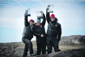  ?? PETER WALL ?? Canada C3 participan­ts Tammy Quinn, left, Mary Simon and Mark Tewksbury hold up bags full of berries after picking them in UMINGMAKTO­K, Nunavut, on leg 10 of the expedition, Aug. 29.