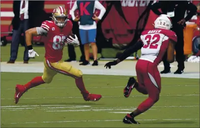  ?? TONY AVELAR — THE ASSOCIATED PRESS ?? San Francisco 49ers tight end George Kittle (85) runs against Cardinals strong safety Budda Baker (32) during the first half on Sunday in Santa Clara.