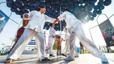  ?? Ahmed Ramzan/Gulf News ?? ■ Members of the Kong Tong and Tai Chi Martial Arts Club demonstrat­e Tai Chi martial art moves at KIte Beach.