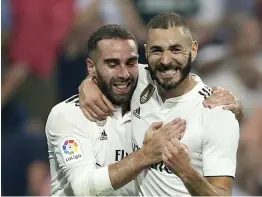  ?? — AP ?? Real Madrid’s Karim Benzema ( right) celebrates with Daniel Carvajal after scoring against Leganes in their La Liga match at Santiago Bernabeu in Madrid on Saturday. The hosts won 4- 1.