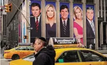  ?? Tribune News Service ?? Advertisem­ents featuring Fox News personalit­ies adorn the front of the News Corporatio­n building in New York City.