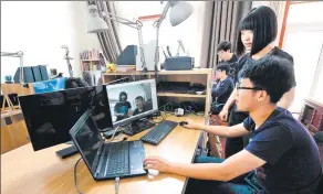  ?? LIU XIAO / XINHUA ?? College students test their artificial intelligen­ce devices in their new tech startup in Xi’an, Shaanxi province.