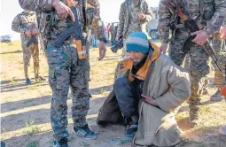  ?? BULENT KILIC/GETTY-AFP ?? A suspected Islamic State fighter is searched Friday by members of the Kurdish-led Syrian Democratic Forces. The U.S.-backed group is closing in on Baghouz, Syria.