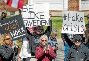  ?? AP ?? Protesters gather outside Minnesota Governor Tim Walz’ official residence in St Paul, Minnesota. President Donald Trump tweeted his support for a protest against Minnesota’s continued stay-at-home order.