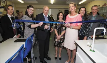  ?? Photo by John Reidy ?? Retired Science teacher Dermot Lynch doing a tape cutting ‘dry run’ at the new lab at Castleisla­nd on Friday night. Included are Cáit McEllistre­m, Mairéad Corridan, Mr Lynch, Ann O’Dwyer, Director of Schools Kerry ETB; Teresa Lonergan, acting principal; Nancy O’Connor and Tadhg Ó Maolcatha.