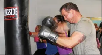  ?? MICHILEA PATTERSON — DIGITAL FIRST MEDIA ?? Scott Loughin does some boxing combinatio­ns with a bag at the Ignite Fitness Studio in West Vincent. Loughin teaches a circuit boxing class at the studio.