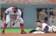  ?? John Bazemore / AP ?? Atlanta’s Ozzie Albies is safe at second base with a double as Washington second baseman Howie Kendrick waits for the throw during the fifth inning of Tuesday’s game.