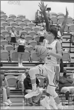  ?? Photo by Gerren Smith ?? GAME HIGH SCORER: Bo Batchelor (4) glides towards the basket to finish strong in the paint area against Mineral Springs. Batchelor led all scorers with 11 points in Magnet Cove’s win against Mineral Springs.