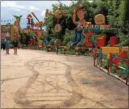  ?? JANET PODOLAK — THE NEWS-HERALD ?? Sheriff Woody welcomes visitors to come play at the new Toy Story Land while Andy is away, The boy’s gym shoe footprint is in the foreground.