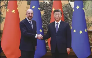  ?? ASSOCIATED PRESS ?? In this photo released by Xinhua News Agency, Chinese President Xi Jinping (right) shakes hands with European Council President Charles Michel, Thursday, before their meeting at the Great Hall of the People in Beijing.