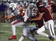  ?? RANDY MEYERS — THE MORNING JOURNAL ?? Bay receiver Francis Sherman fights for yards after a catch as Ross Hartman of Rocky River hangs on during the first quarter on Sept. 28.