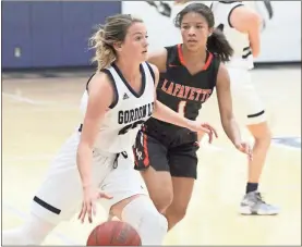  ?? Scott Herpst, file photo ?? Gordon Lee’s Emma Mcgraw drives into the lane past Lafayette’s Kloe Ludy during a recent game in Chickamaug­a. The Lady Trojans defeated Heritage Saturday night for their first win of the season.