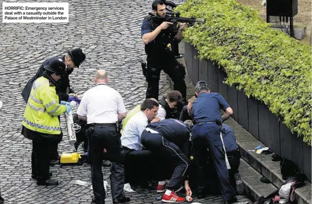  ??  ?? HORRIFIC: Emergency services deal with a casualty outside the Palace of Westminste­r in London