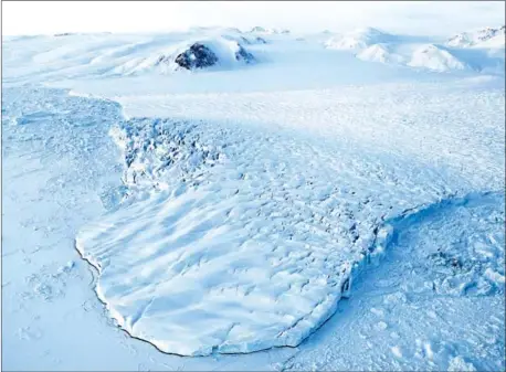  ?? MARIO TAMA/AFP ?? Nasa’s Operation IceBridge research aircraft captures the ice fields of Ellesmere Island in Canada. Global warming is heating the Arctic at a record pace, a major US scientific report said on Tuesday.