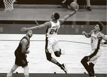  ?? Karen Warren / Staff photograph­er ?? Spurs guard Devin Vassell dunks against Eric Gordon and the Rockets during a recent game. The Rockets are allowing 118.5 points per game with a defensive rating that ranks 25th in the NBA.