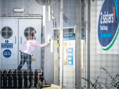  ?? Picture: Mhairi Edwards. ?? A member of staff at the 2 Sisters plant uses hand sanitiser on site.