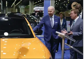  ?? (AP/Evan Vucci) ?? President Joe Biden looks at a Ford Mustang with Bill Ford, executive chairman of Ford Motor Company, during a tour in September at the Detroit Auto Show in Detroit.