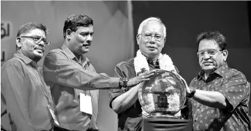  ??  ?? Najib with IPF president Senator Datuk M. Sambanthan and BN secretary-general Datuk Seri Tengku Adnan Tengku Mansor (right) at the closing of the 25th IPF General Assembly . - Bernama photo