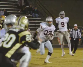  ??  ?? Cedartown’s Quan Neal (33) looks for an open hole after taking a handoff from quarterbac­k Trevon Wofford (9) during Friday’s game at Pepperell.