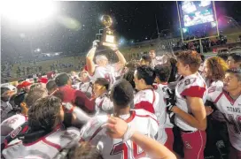  ?? [PHOTO BY SARAH PHIPPS, THE OKLAHOMAN] ?? Carl Albert’s Jake Hill celebrates the 5A state football championsh­ip over Bishop McGuinness at Wantland Stadium in Edmond.