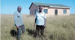  ?? Picture: ZIYANDA ZWENI ?? FORLORN: Headman Mthethunzi­ma Ndamase and Nonjani Ncele stand outside the temporary clinic that was built by villagers in Mthombe administra­tion area in 2015.