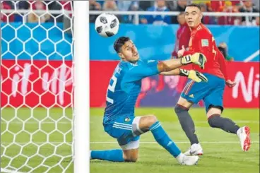  ?? AP ?? ▪ Iago Aspas watches his back heel beat Morocco goalkeeper Monir El Kajoui as Spain snatched a 22 draw on Monday.
