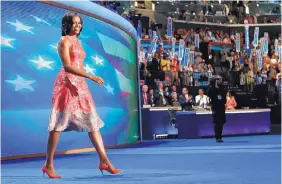  ?? JAE C. HONG/ASSOCIATED PRESS ?? First lady Michelle Obama, dressed in a Tracy Reese pink silk jaquard dress, walks on the stage at the Democratic National Convention in Charlotte, N.C., in 2012.