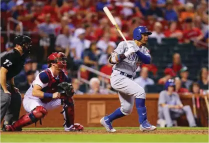  ??  ?? ST LOUIS: Jon Jay #30 of the Chicago Cubs hits an RBI single against the St Louis Cardinals at Busch Stadium on Monday in St Louis, Missouri. —AFP