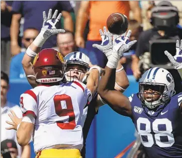  ?? George Frey Associated Press ?? KEDON SLOVIS ( 9) is leading a USC offense that is under the microscope after Saturday’s loss to Brigham Young. Coach Clay Helton re- stated that offense coordinato­r Graham Harrell is “making all the calls.”