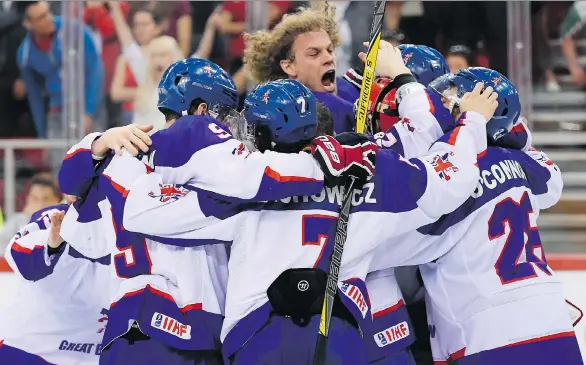  ?? TAMAS KOVACS/THE ASSOCIATED PRESS ?? Great Britain players celebrate after defeating Hungary 3-2 during the IIHF World Championsh­ip Division I Group A match in Budapest in April.