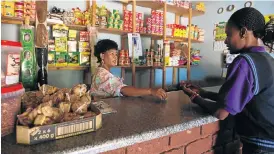  ??  ?? ON TICK: Nomsa Maleka runs her spaza shop largely by extending credit to grant recipients
