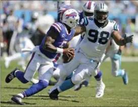  ?? MIKE MCCARN — ASSOCIATED PRESS ?? Tyrod Taylor scrambles under pressure from the Panthers’ Star Lotulelei on Sept. 17, 2017 in Charlotte, N.C.