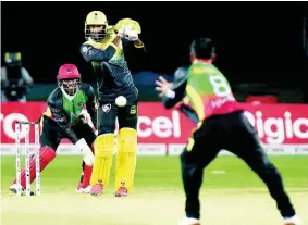  ?? IAN ALLEN PHOTOS ?? Imran Khan (centre) from the Jamaica Tallawahs is bowled and caught by Mohammed Hafeez (right) from St.Kitts and Nevis Patriots, while the wicketkeep­er Devon Thomas (left) looks on.
