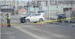  ?? SHAUGHN BUTTS ?? Police probe a three-car collision on 66 Street north of Yellowhead Trail on Sunday. A man who was in the black car was killed.